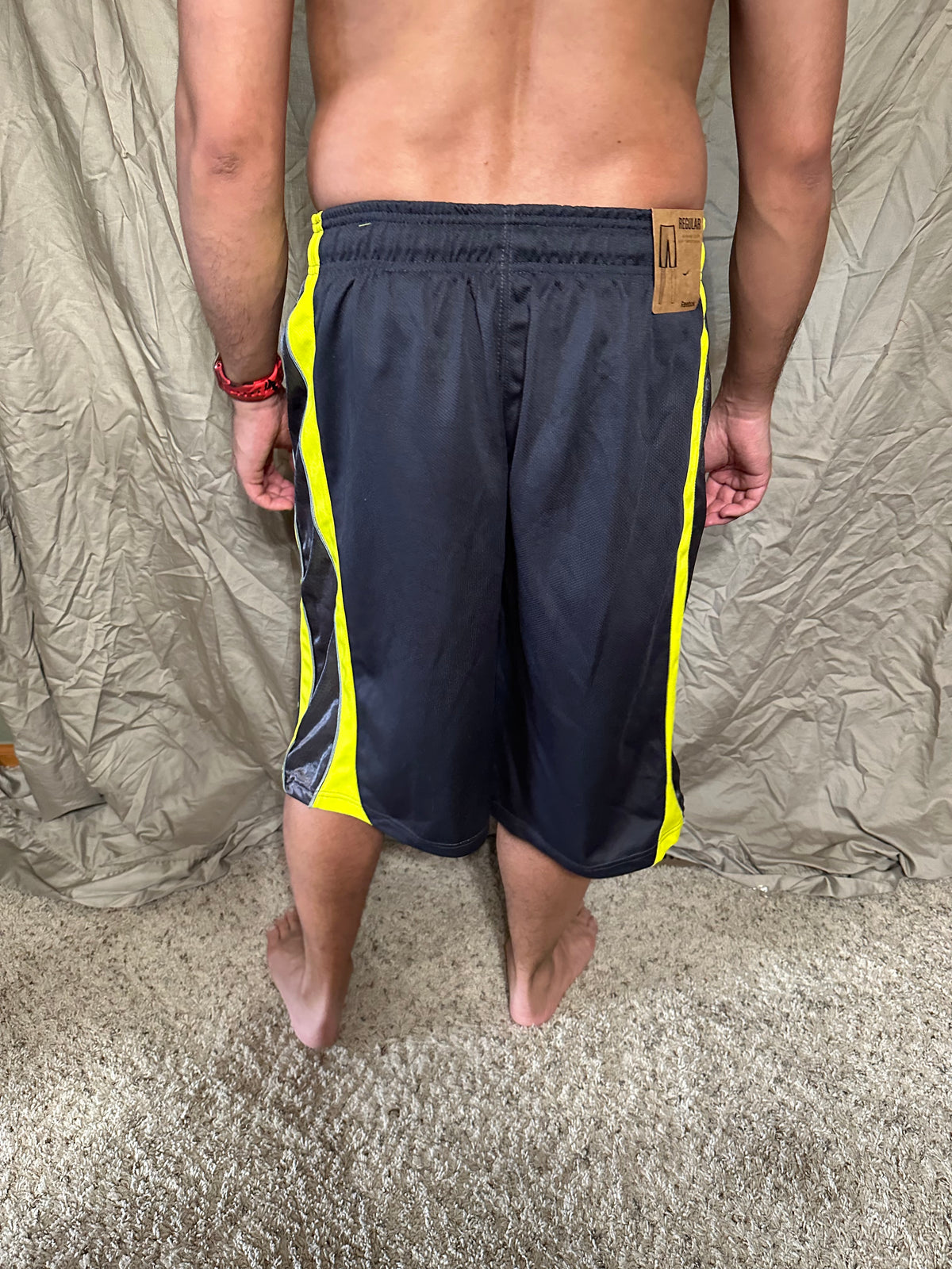 Men’s grey and yellow Reebok size medium performance athletic shorts with pockets
